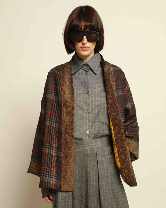 Model is wearing the Obidi Checked Kantha Jacket in wool and silk, with a silk collar and unique printed silk lining, a one-of-a-kind artisanal piece. Part of House of Woven Stories selection.