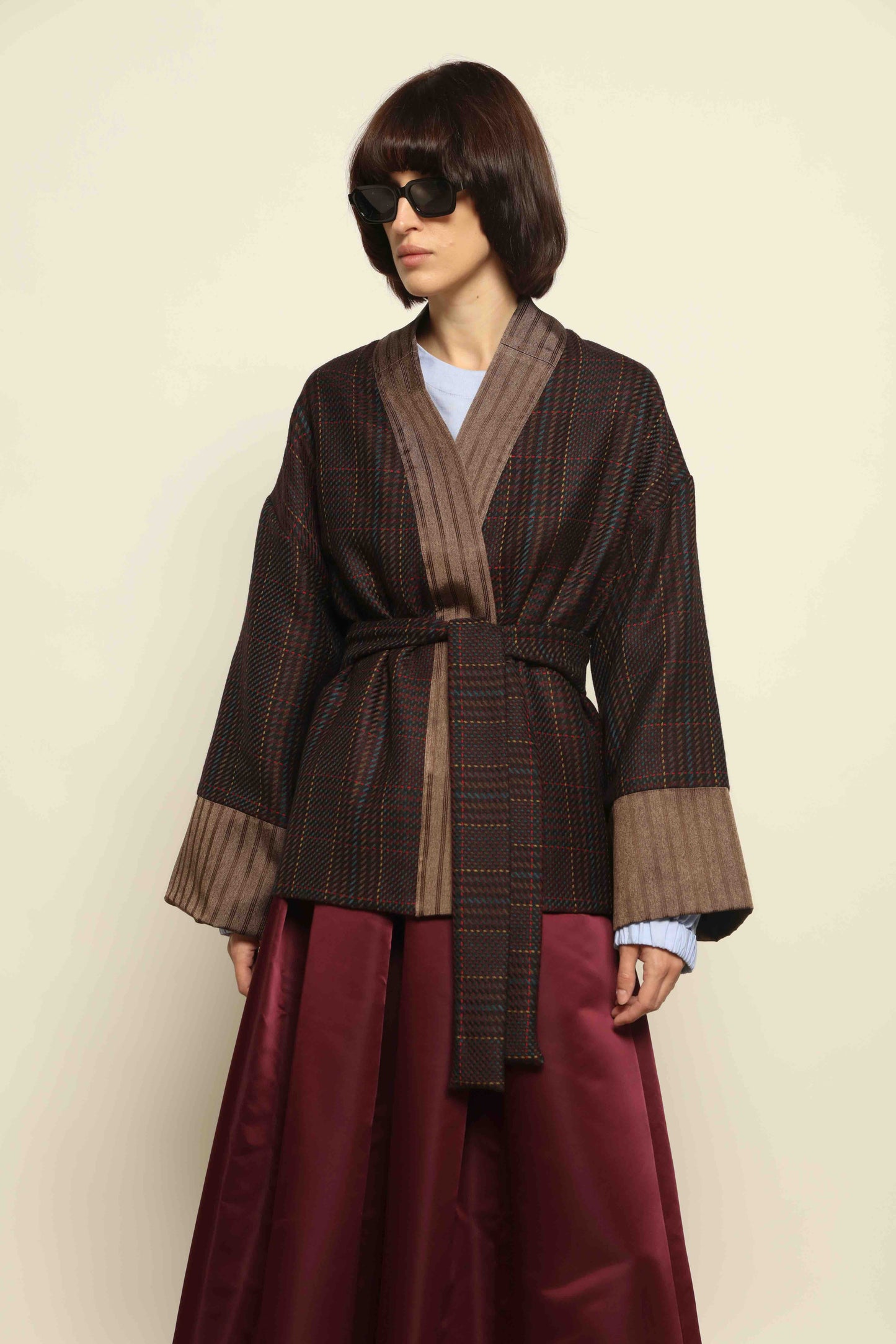 Model is wearing the Obidi Checked Kantha Jacket in wool and silk with a refined silk collar and unique printed silk lining, crafted with artisanal Kantha technique. Part of House of Woven Stories selection.