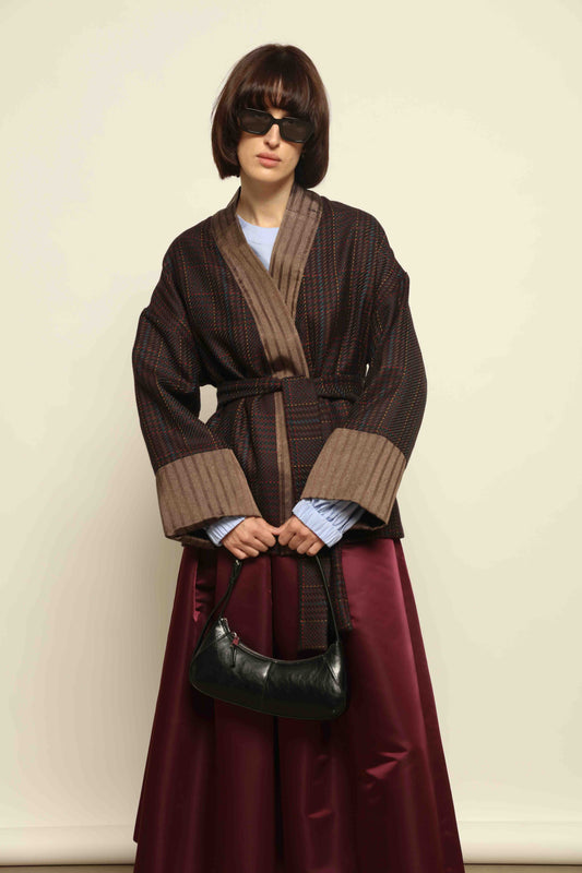 Model is wearing the Obidi Checked Kantha Jacket in wool and silk with a refined silk collar and unique printed silk lining, crafted with artisanal Kantha technique. Part of House of Woven Stories selection.
