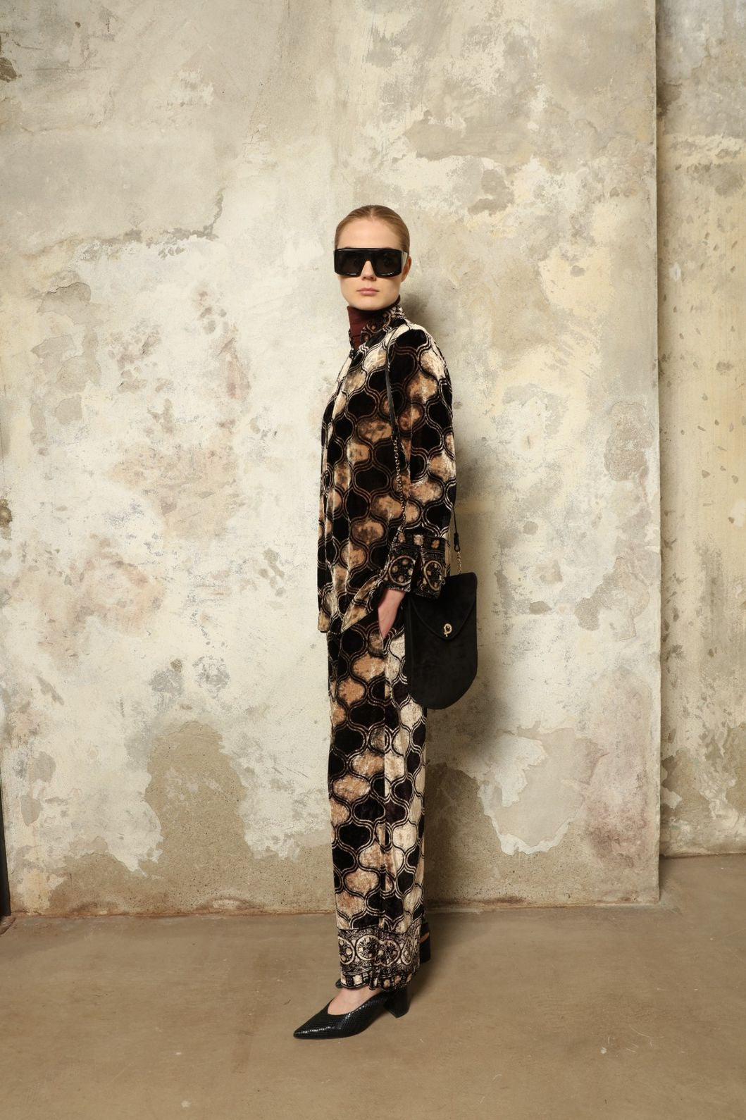 Model is wearing The Obsidian Cleo Jacket by Obidi, crafted from luxurious velvet with a structured yet fluid silhouette, blending contemporary design with traditional craftsmanship.
