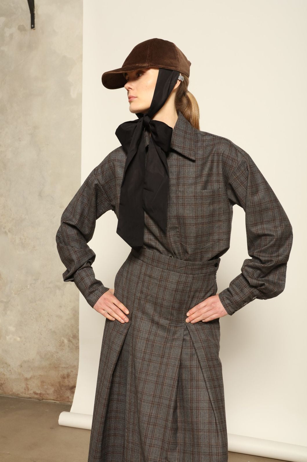 Model is wearing the Oscar Grey Brown Shirt by House of Woven Stories, made from 100% merino wool with a timeless tailored silhouette in grey-brown tones.