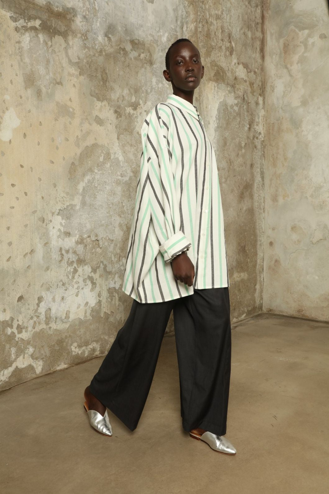 Model is wearing the Oversized Shirt with Collar by Marrakshi Life, part of House of Nomad Stories collection, handwoven cotton shirt with relaxed architectural fit, structured collar, and versatile styling