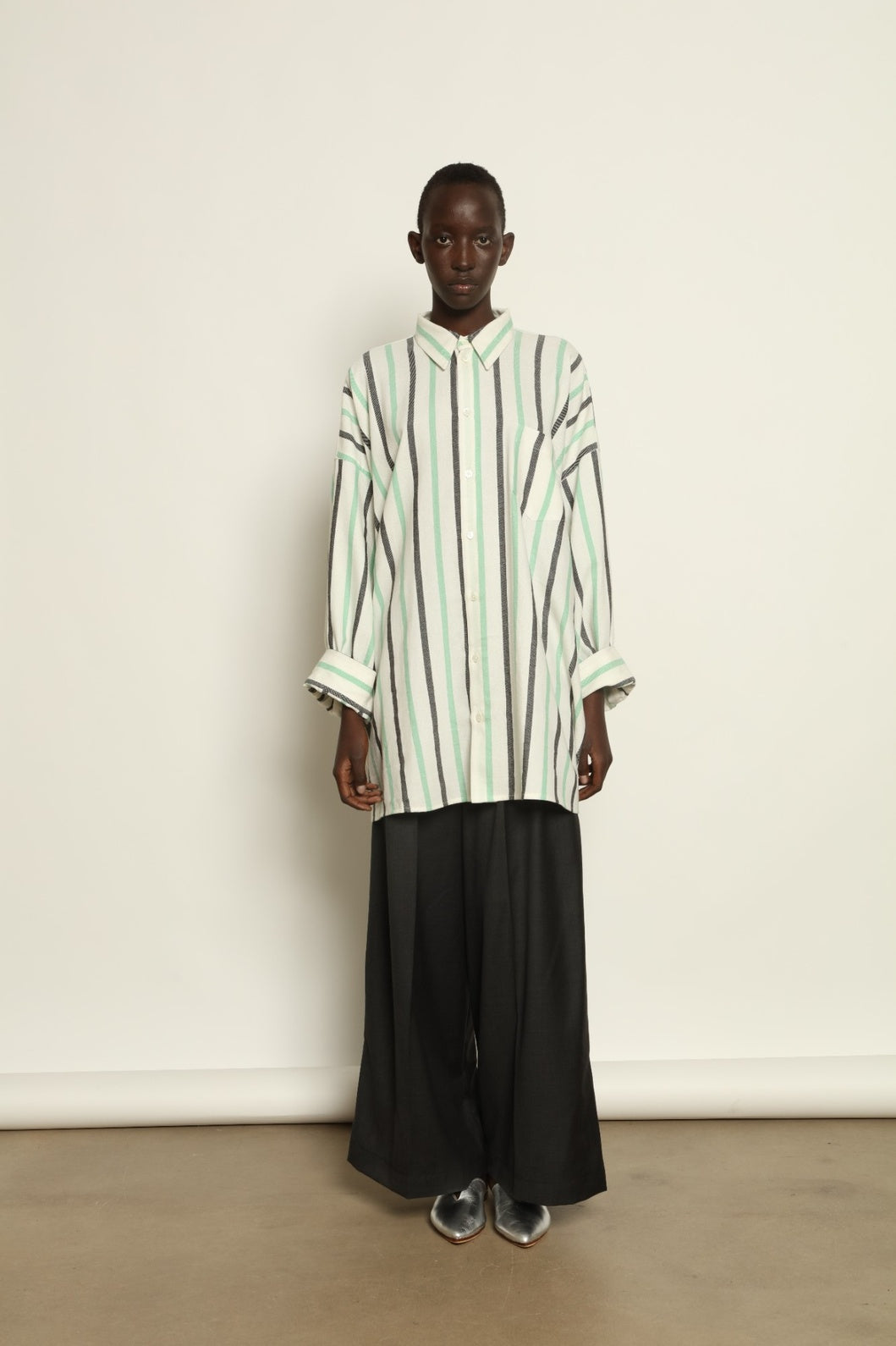 Model is wearing the Oversized Shirt with Collar by Marrakshi Life, part of House of Nomad Stories collection, handwoven cotton shirt with relaxed architectural fit, structured collar, and versatile styling