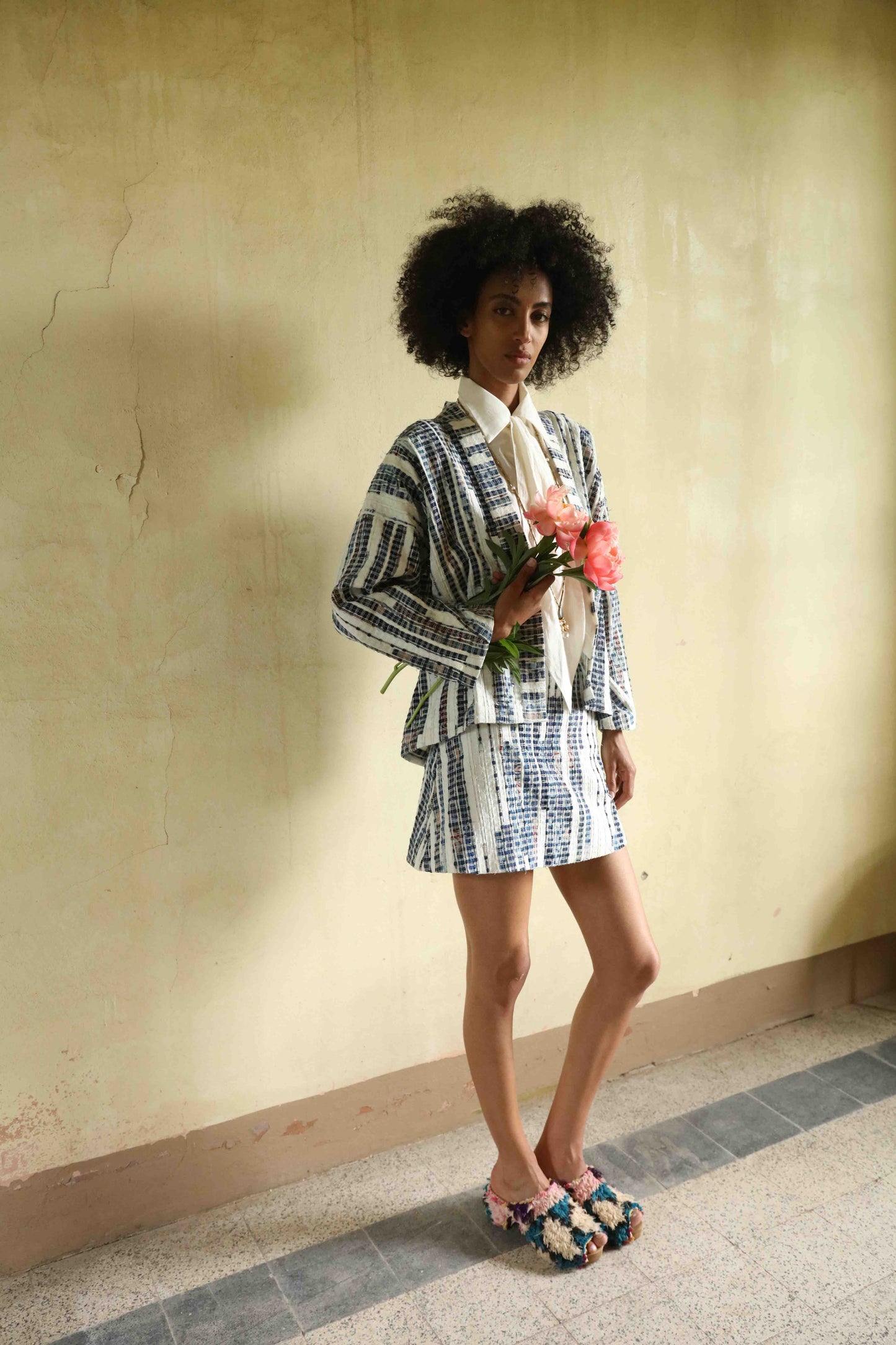 Handwoven mini skirt in upcycled blue and white cotton fabric with voile lining. Sustainable, eco-friendly fashion by Paiwand. Artisan-crafted, ethical clothing with unique texture. Matching kimono available. Part of House of Woven Stories curated collection.