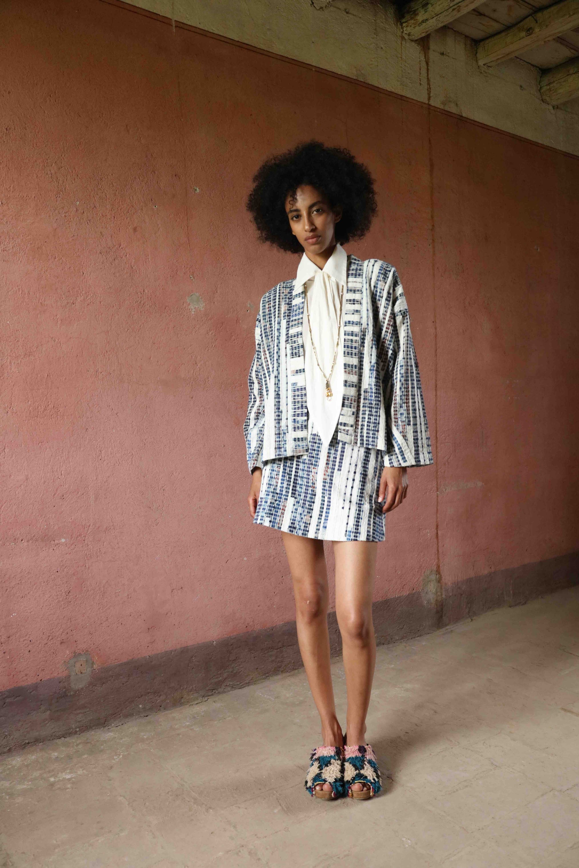 Handwoven from upcycled blue and white fabric waste, this lightweight kimono by Paiwand features a soft, textured finish and celebrates the beauty of conscious craftsmanship and subtle imperfections. Part of House of Woven Stories selection.