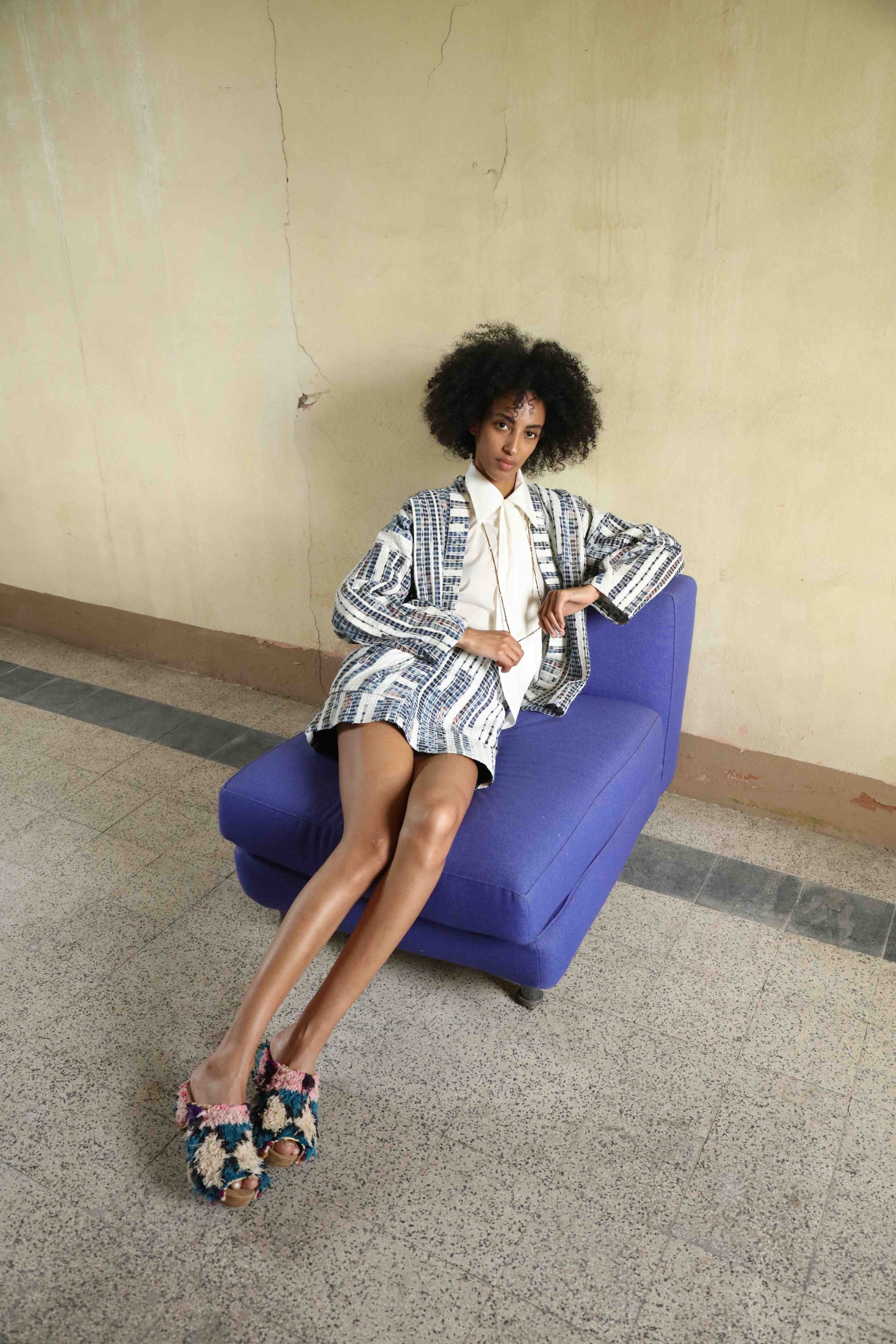 Handwoven from upcycled blue and white fabric waste, this lightweight kimono by Paiwand features a soft, textured finish and celebrates the beauty of conscious craftsmanship and subtle imperfections. Part of House of Woven Stories selection.