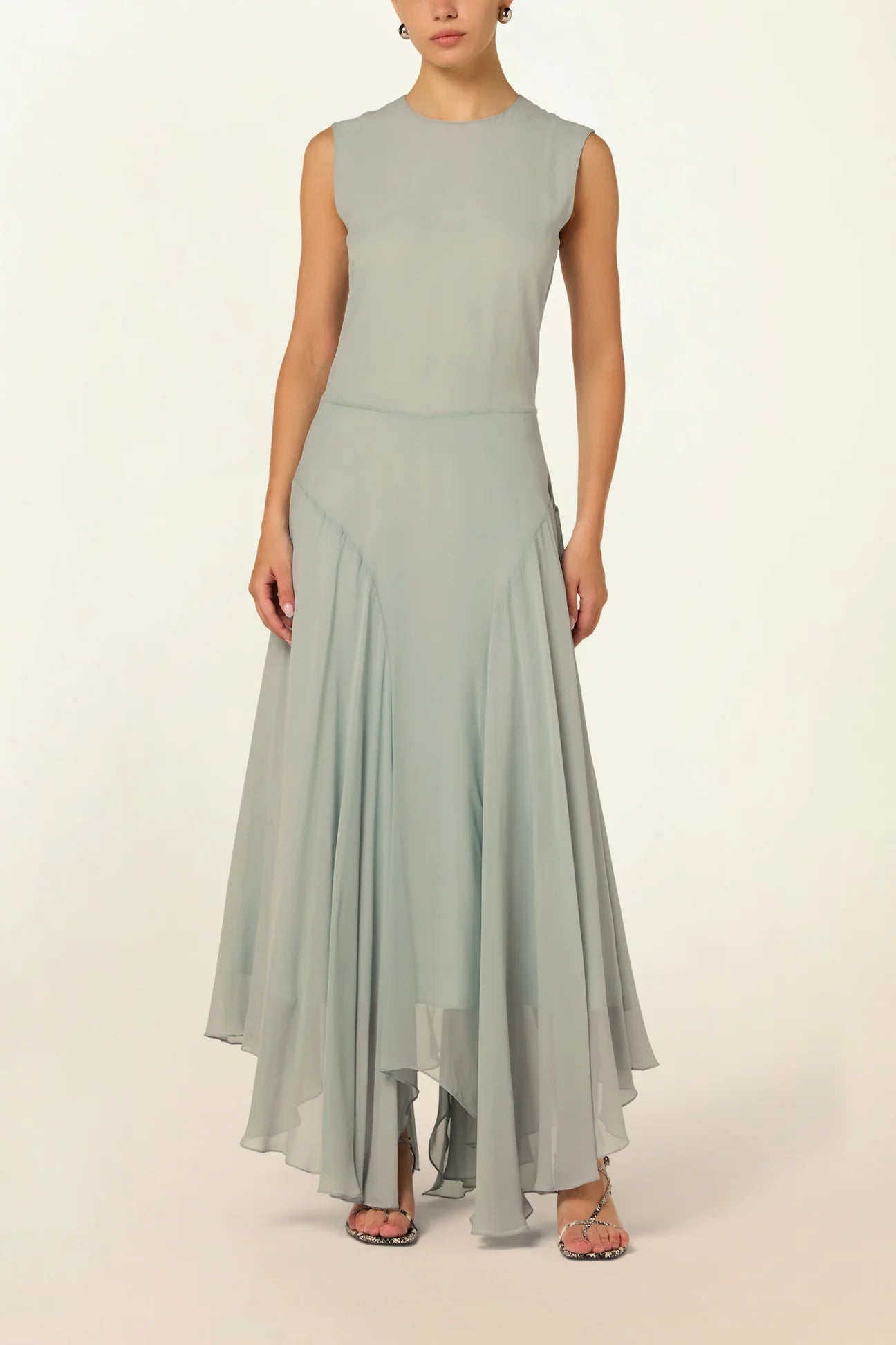 Model wearing a blue Panelled Dress by Abadia from the House of Nomad Stories collection, featuring a sleeveless midi silhouette, round neckline, and structured waist panel detailing with a minimal elegant finish.