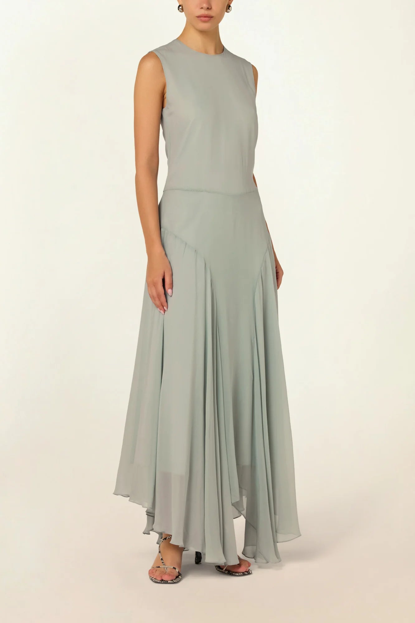 Model wearing a blue Panelled Dress by Abadia from the House of Nomad Stories collection, featuring a sleeveless midi silhouette, round neckline, and structured waist panel detailing with a minimal elegant finish.