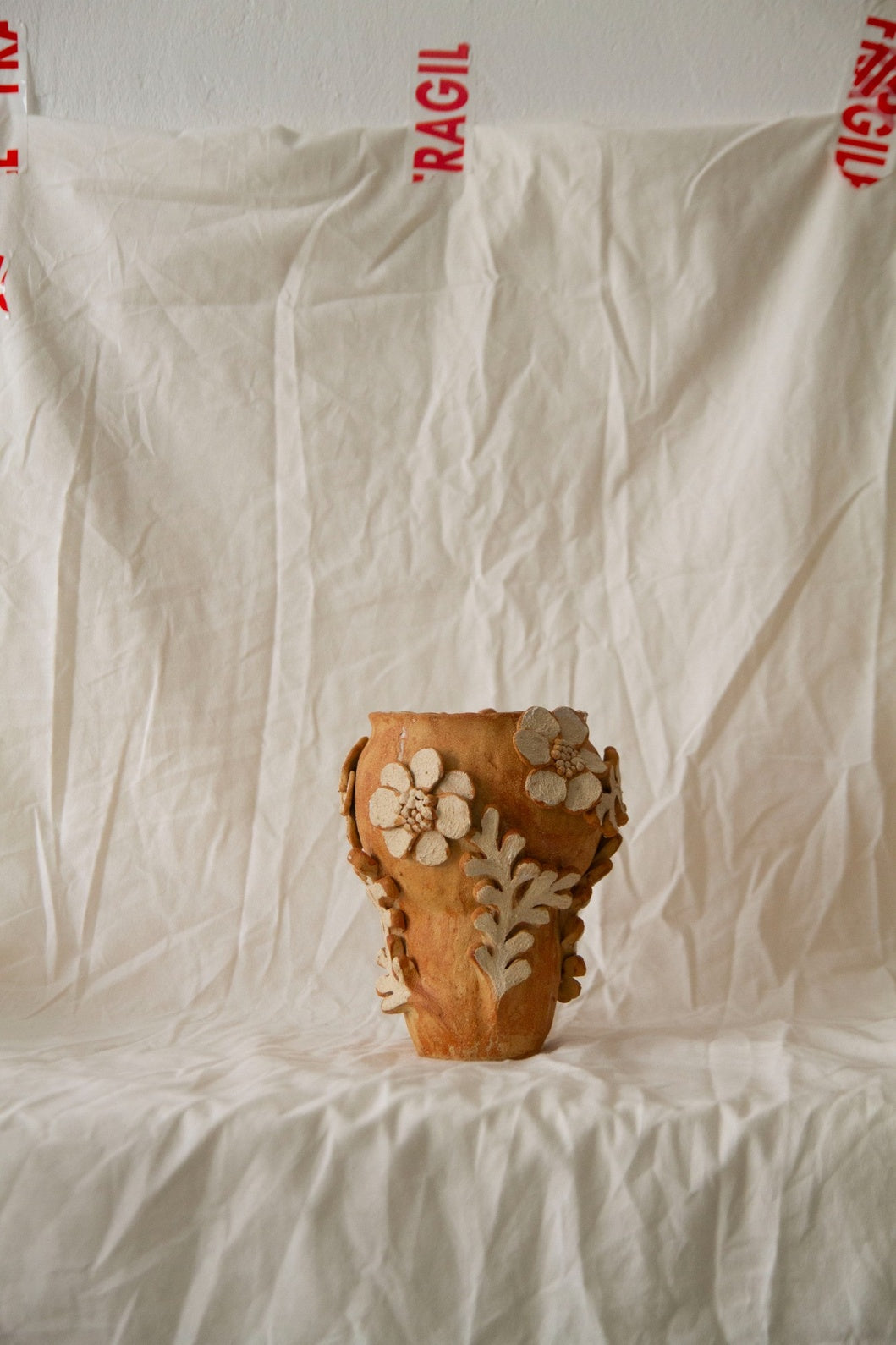 Petit Jardin n.05 by Clandestine Céramique, handmade in warm brown clay with a natural glossy glaze and hand-painted floral motifs, part of the House of Woven Stories selection.