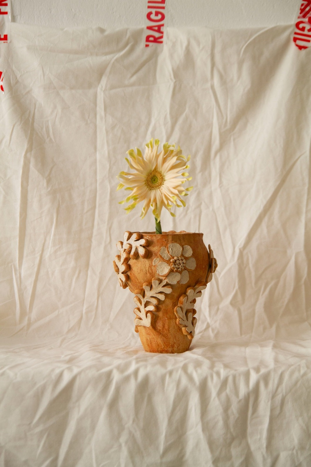 Petit Jardin n.05 by Clandestine Céramique, handmade in warm brown clay with a natural glossy glaze and hand-painted floral motifs, part of the House of Woven Stories selection.