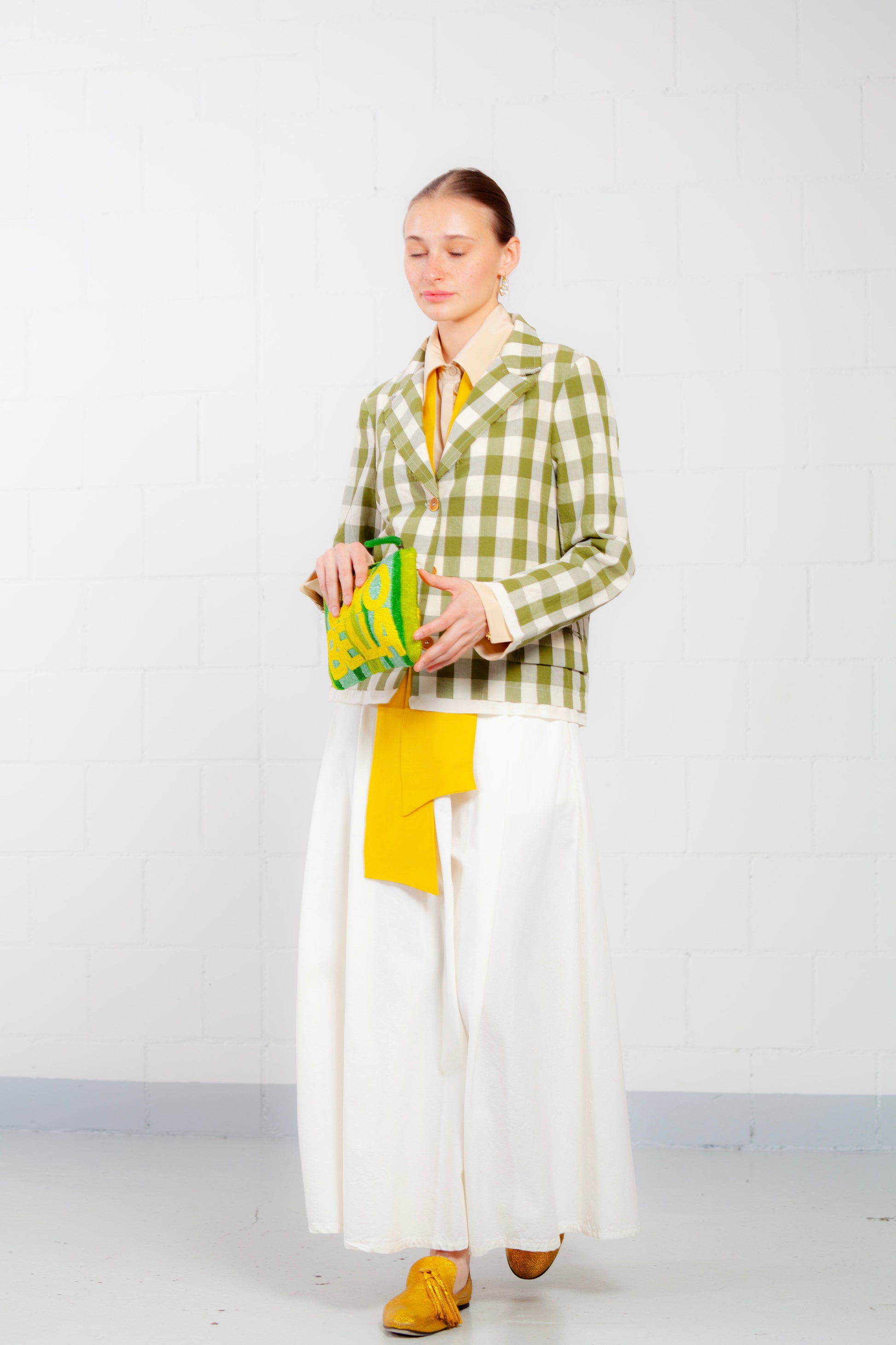 Model is wearing the Pine Checked Cotton and Linen Jacket by Balia 8.22, featuring a classic tailored fit, pine green and white checked pattern, and breathable Italian craftsmanship.
