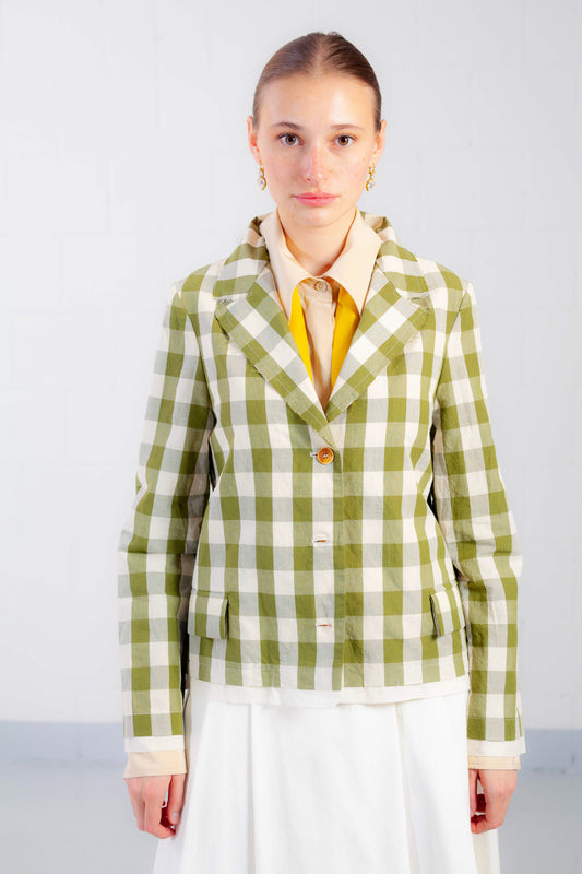 Model is wearing the Pine Checked Cotton and Linen Jacket by Balia 8.22, featuring a classic tailored fit, pine green and white checked pattern, and breathable Italian craftsmanship.