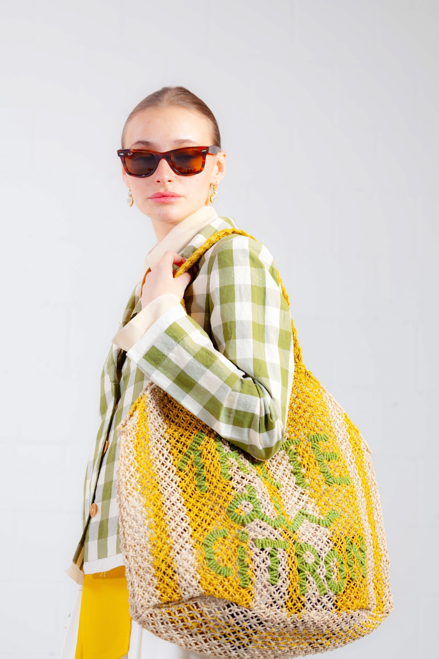 Model is wearing the Pine Checked Cotton and Linen Jacket by Balia 8.22, featuring a classic tailored fit, pine green and white checked pattern, and breathable Italian craftsmanship.