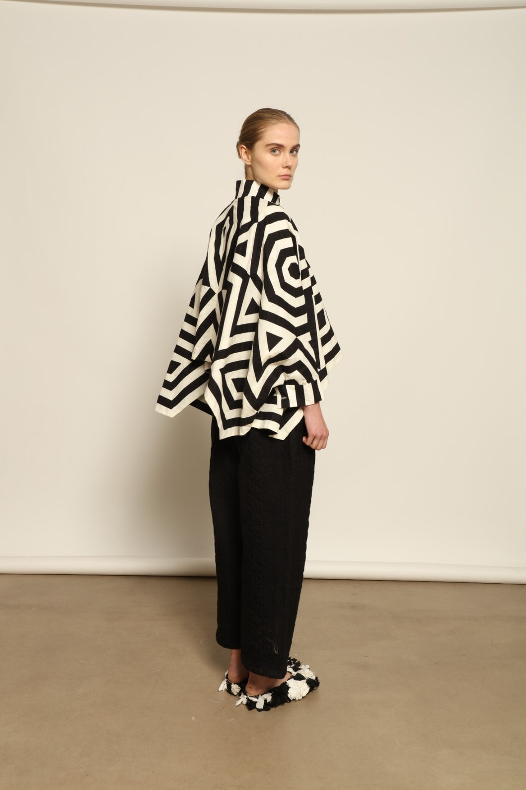 Model wearing Pure Cotton Tantra Black and White Jacket by Ka-Sha, part of the curated House of Woven Stories selection, handcrafted in India from premium cotton with hand-dyed appliqué detailing and a relaxed, artistic silhouette.
