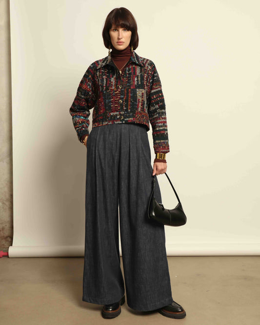 Model is wearing the Rewoven Hand-loomed Bomber by Paiwand, an upcycled unisex jacket crafted from handwoven organic cotton off-cuts with unique color and design variations.