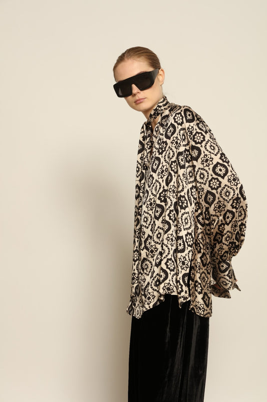 Model is wearing the Rose Silk Sutra Shirt by Obidi, crafted from pure silk with a soft, lightweight fabric and relaxed silhouette, combining timeless craftsmanship with modern style.