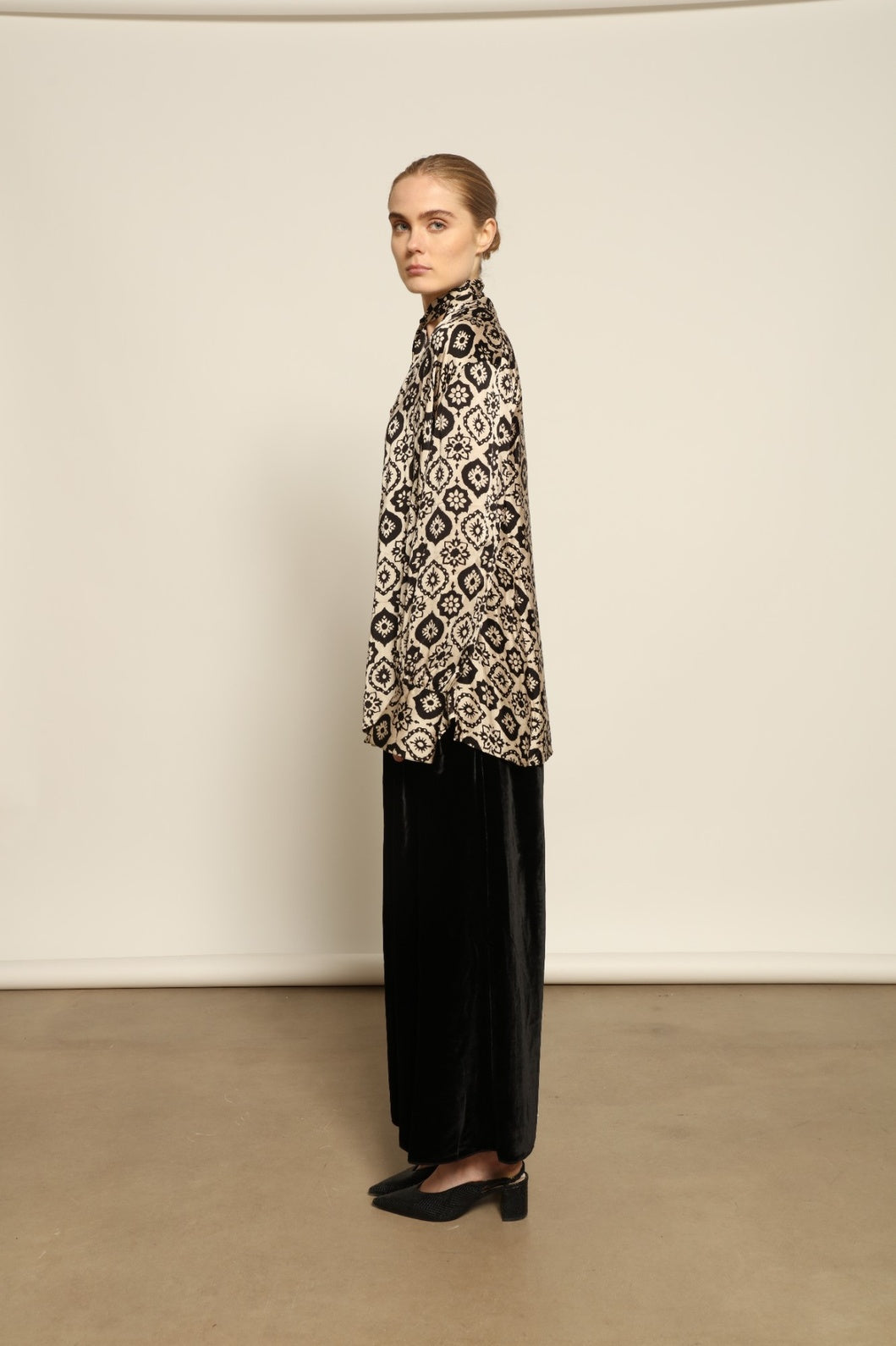 Model is wearing the Rose Silk Sutra Shirt by Obidi, crafted from pure silk with a soft, lightweight fabric and relaxed silhouette, combining timeless craftsmanship with modern style.