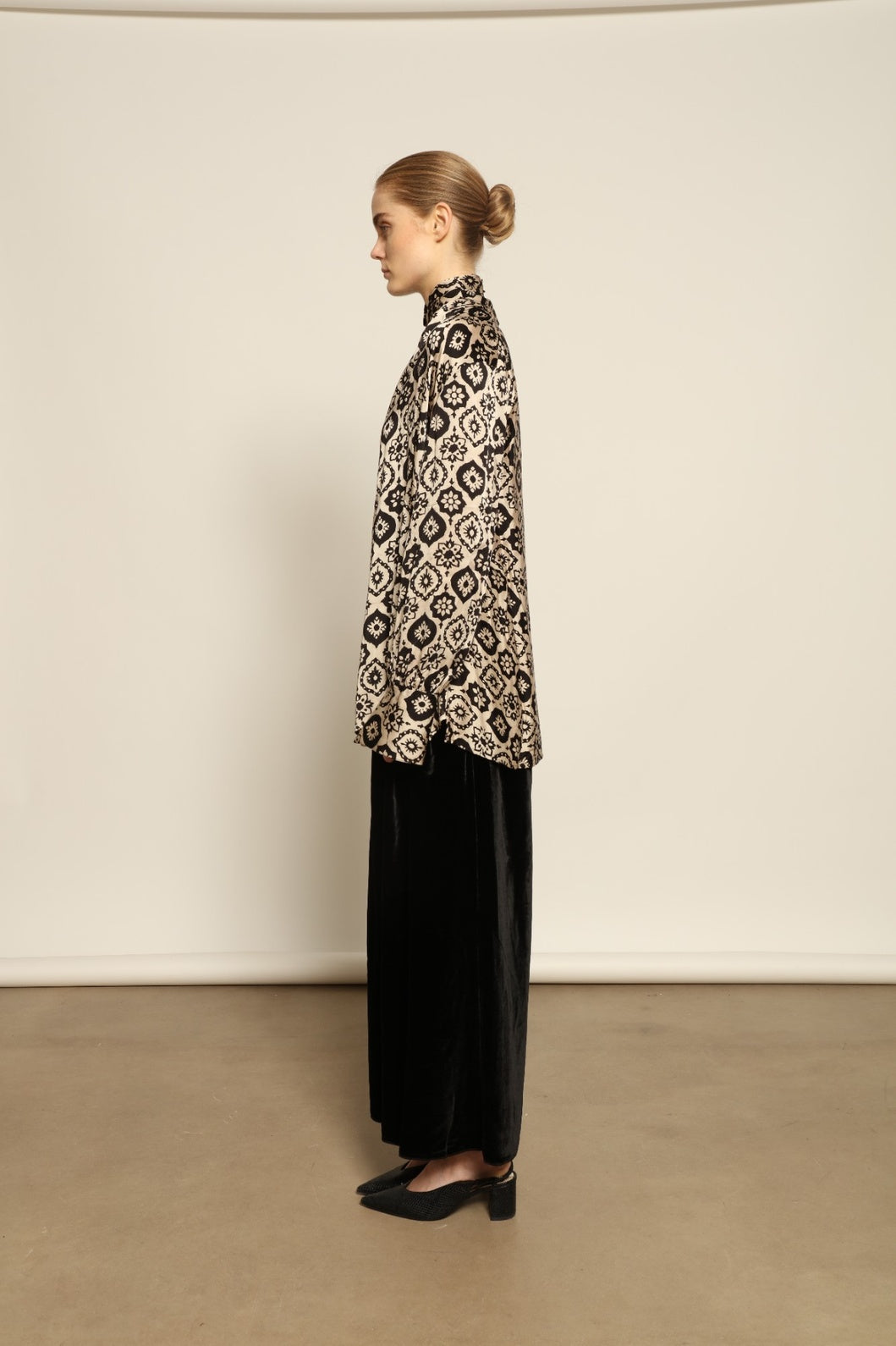 Model is wearing the Rose Silk Sutra Shirt by Obidi, crafted from pure silk with a soft, lightweight fabric and relaxed silhouette, combining timeless craftsmanship with modern style.