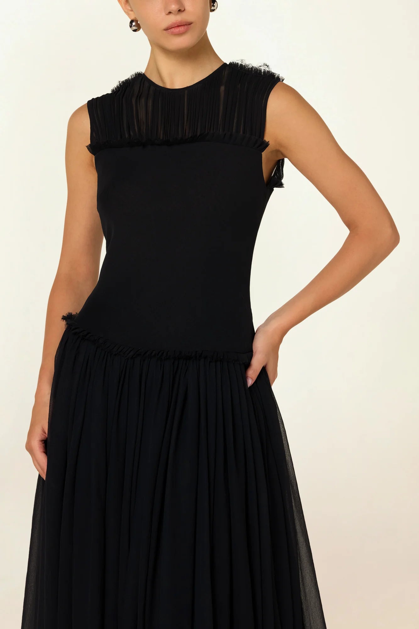 Model wearing a black silk Sera Dress by Abadia from the House of Nomad Stories collection, featuring a fitted bodice and fluid midi skirt with an elegant lightweight drape.