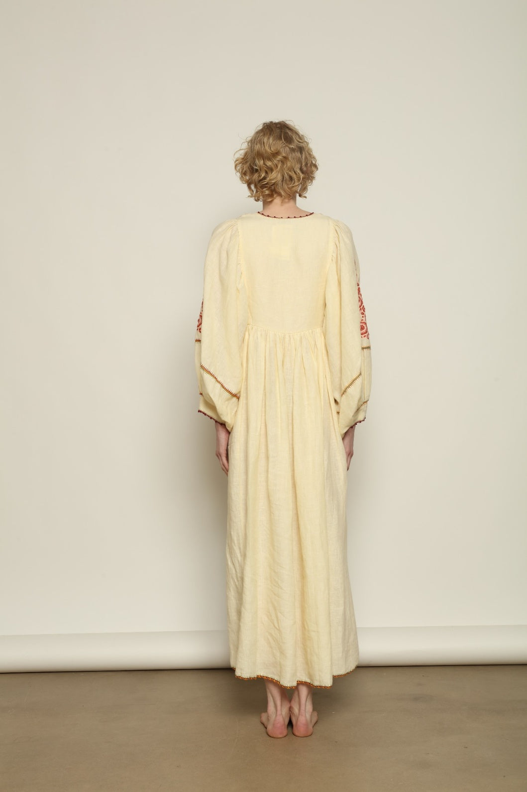 Model is wearing the Serafina Embroidered Rose Linen Dress by Supernaturae x HONS in soft earthy rose linen, featuring delicate hand embroidery across a breathable pure linen fabric. Part of the House of Woven Stories selection, this ethical artisan-crafted dress reflects ancestral techniques and sustainable production, with subtle natural variations in texture and stitch, designed in a relaxed fluid silhouette, worn by model 1.79m size S.