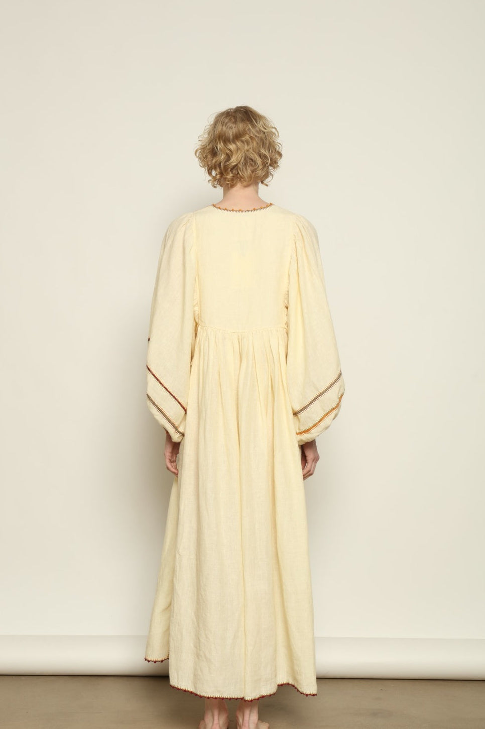 Model is wearing the Serafina Rose Linen Dress by Supernaturae, a plant-dyed linen and handwoven silk dress with adjustable side ties from the curated House of Woven Stories selection.