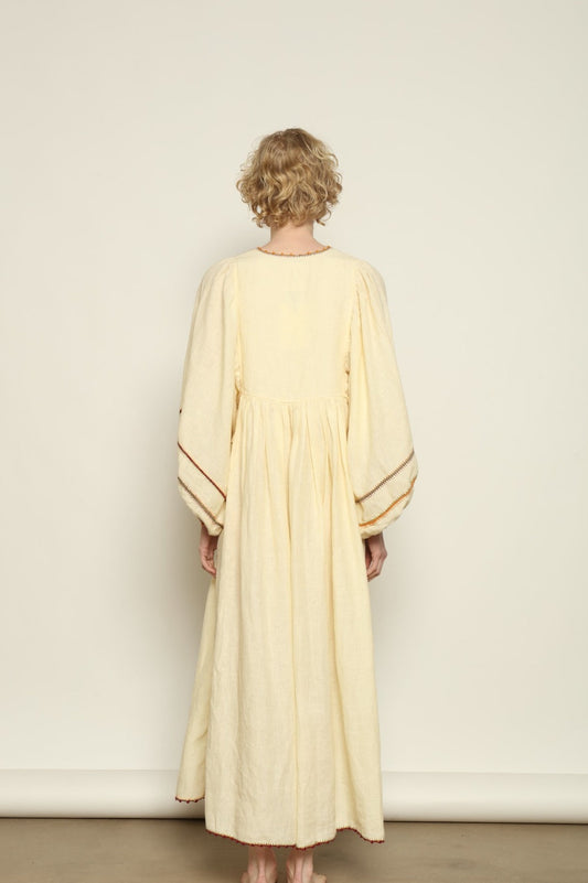 Model is wearing the Serafina Rose Linen Dress by Supernaturae, a plant-dyed linen and handwoven silk dress with adjustable side ties from the curated House of Woven Stories selection.