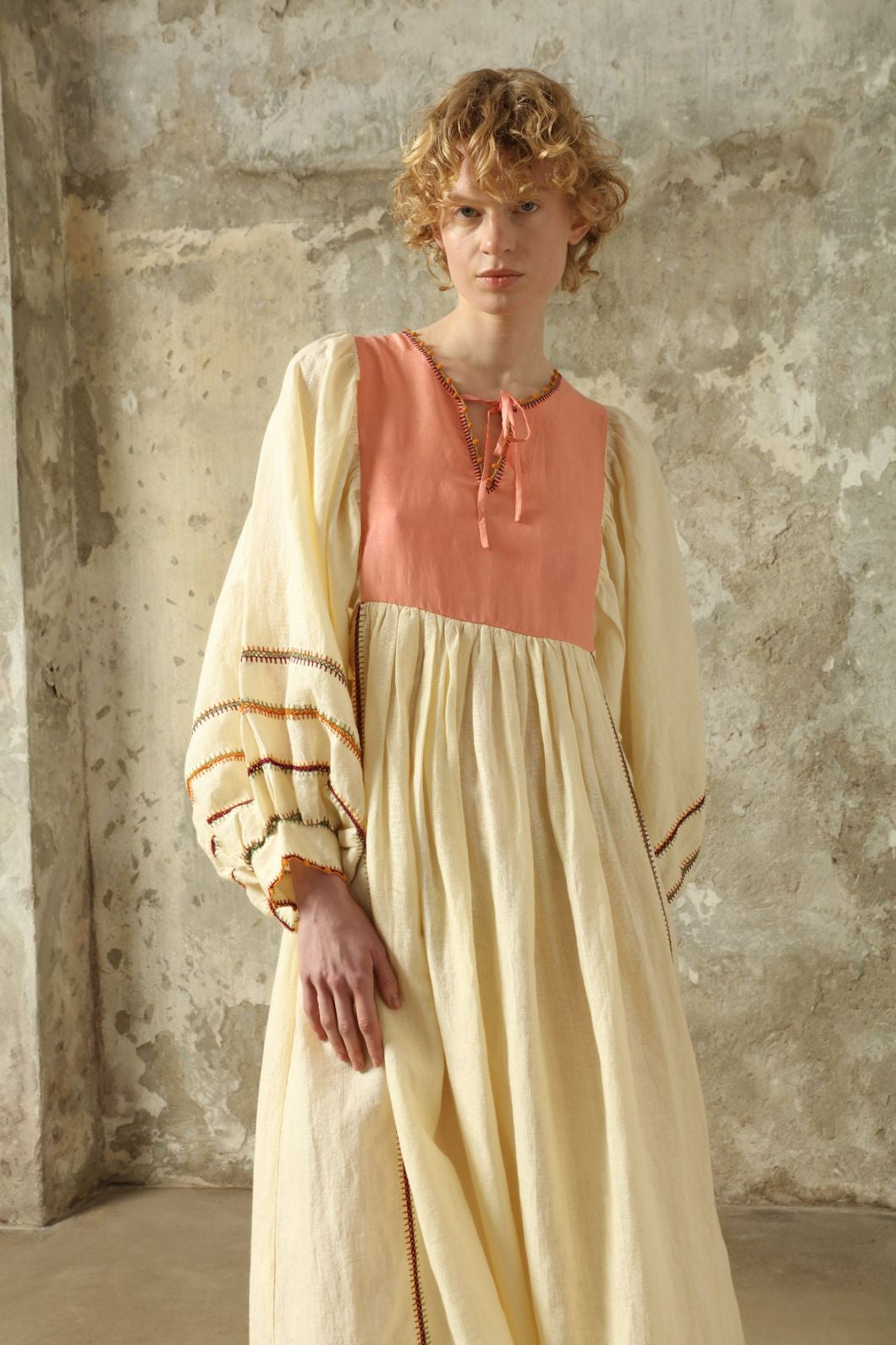 Model is wearing the Serafina Rose Linen Dress by Supernaturae, a plant-dyed linen and handwoven silk dress with adjustable side ties from the curated House of Woven Stories selection.