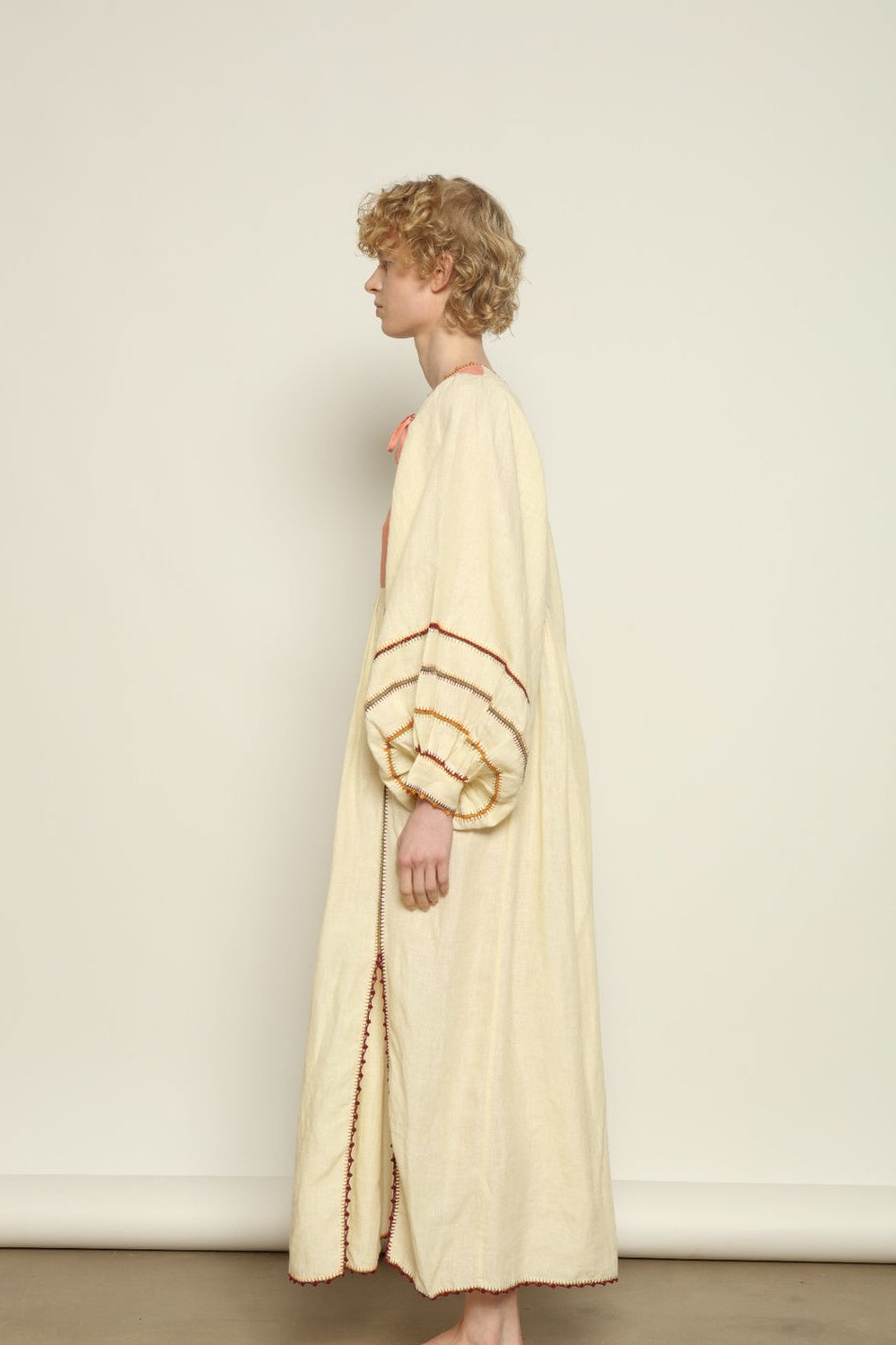 Model is wearing the Serafina Rose Linen Dress by Supernaturae, a plant-dyed linen and handwoven silk dress with adjustable side ties from the curated House of Woven Stories selection.