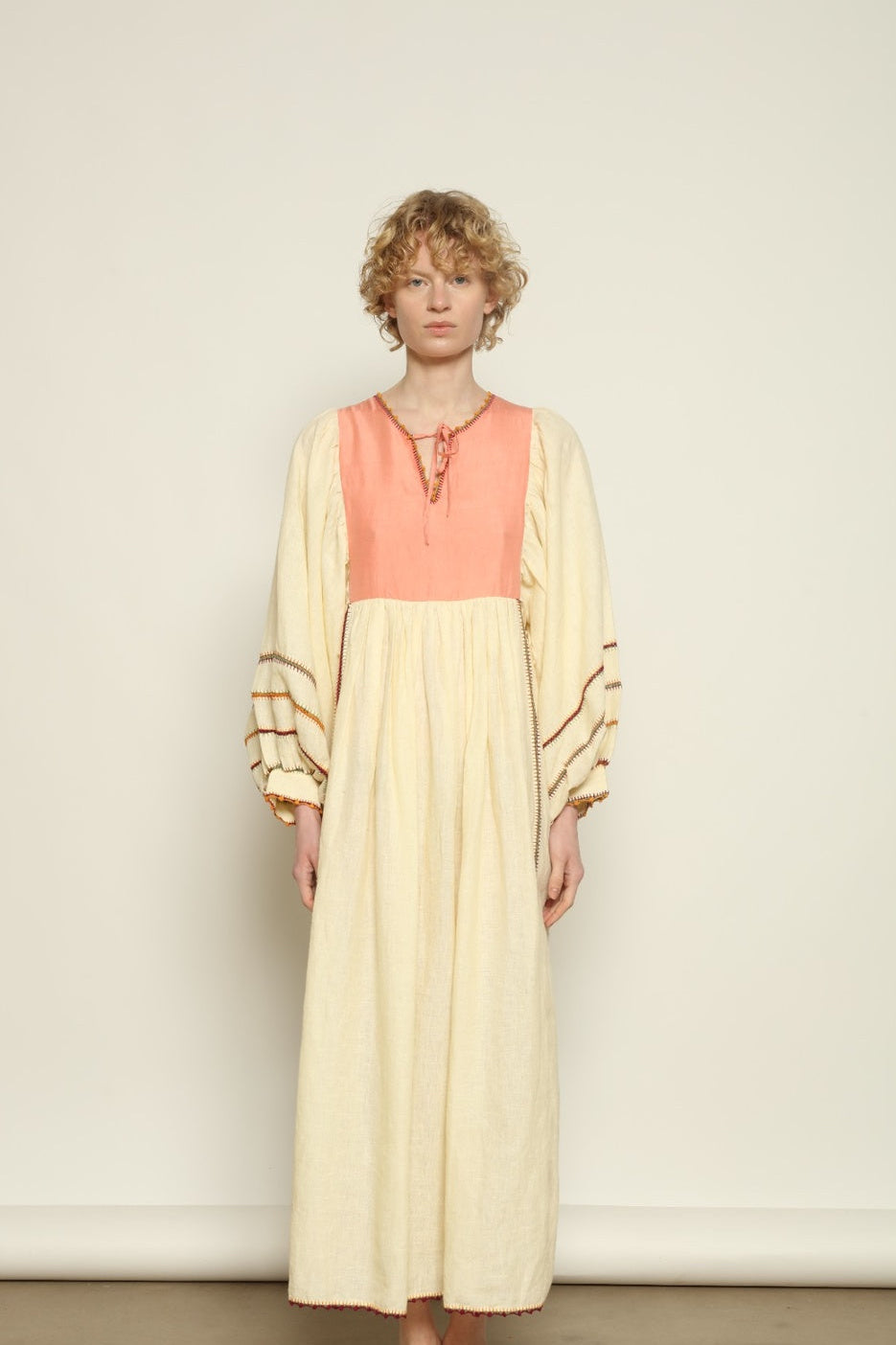 Model is wearing the Serafina Rose Linen Dress by Supernaturae, a plant-dyed linen and handwoven silk dress with adjustable side ties from the curated House of Woven Stories selection.
