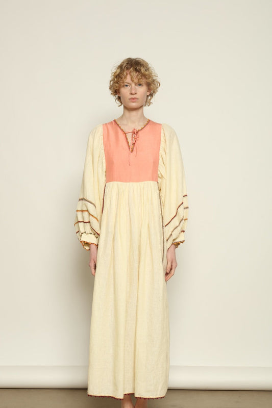 Model is wearing the Serafina Rose Linen Dress by Supernaturae, a plant-dyed linen and handwoven silk dress with adjustable side ties from the curated House of Woven Stories selection.