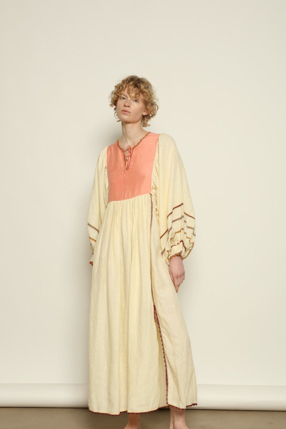 Model is wearing the Serafina Rose Linen Dress by Supernaturae, a plant-dyed linen and handwoven silk dress with adjustable side ties from the curated House of Woven Stories selection.