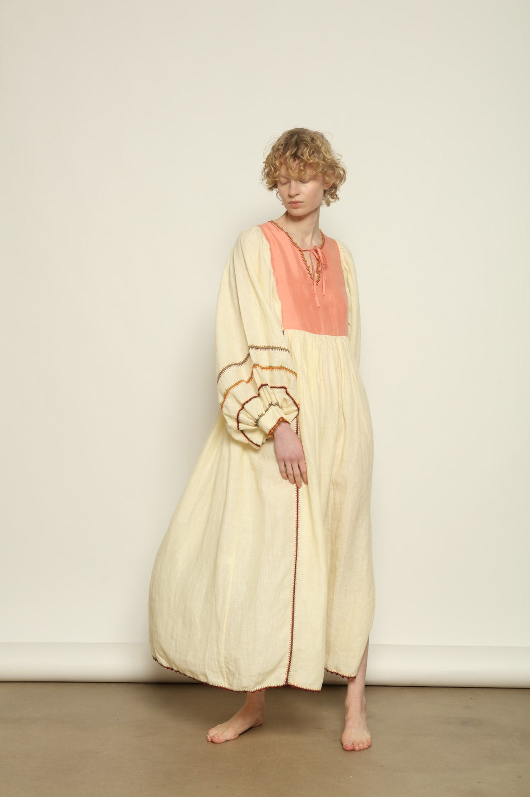 Model is wearing the Serafina Rose Linen Dress by Supernaturae, a plant-dyed linen and handwoven silk dress with adjustable side ties from the curated House of Woven Stories selection.