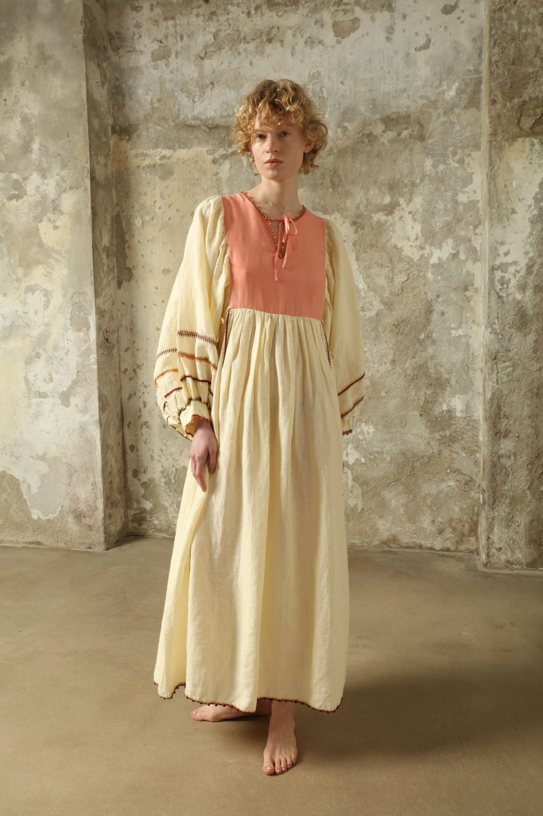 Model is wearing the Serafina Rose Linen Dress by Supernaturae, a plant-dyed linen and handwoven silk dress with adjustable side ties from the curated House of Woven Stories selection.