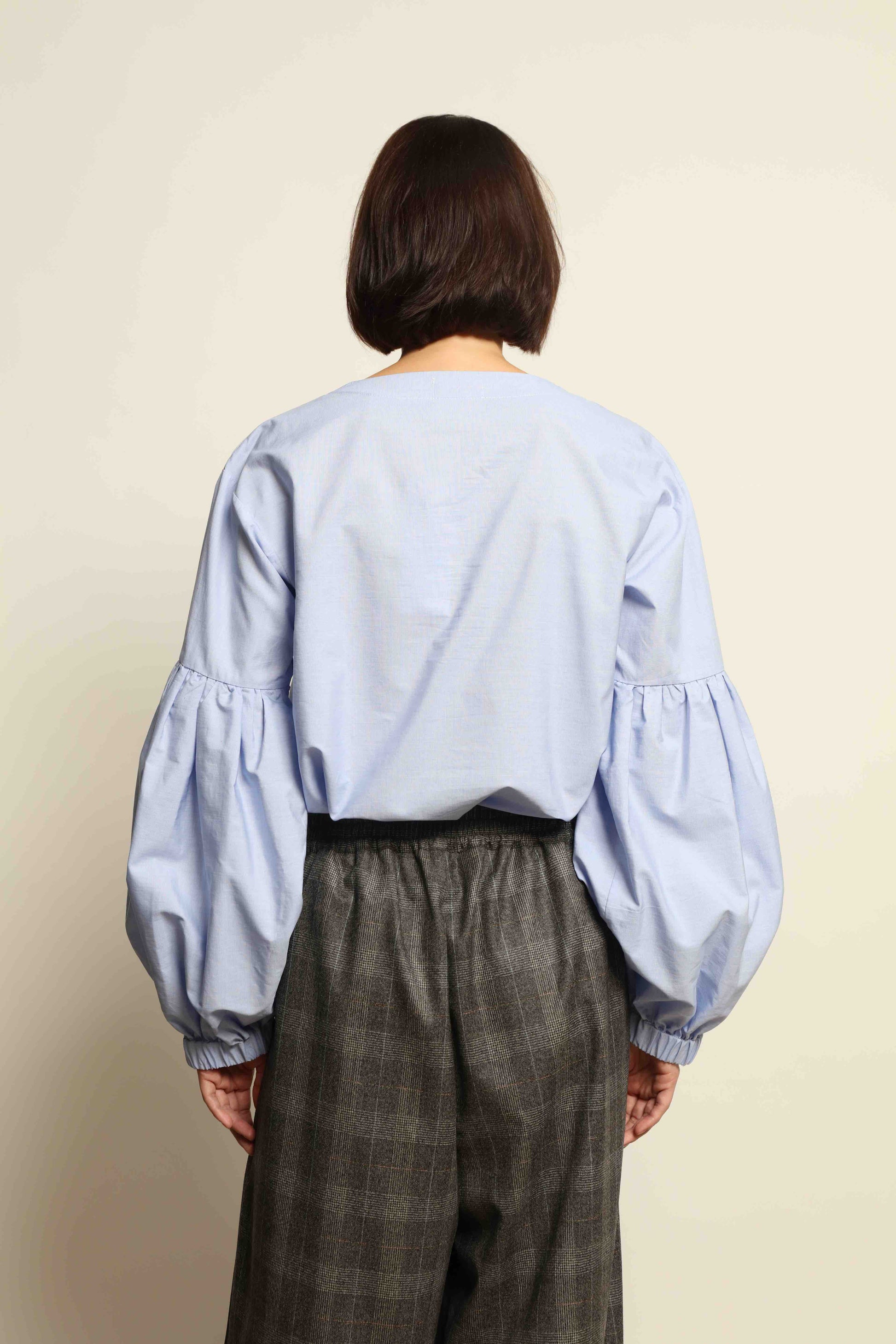 Model wearing the Sky Blue Lulu Pure Poplin Cotton Blouse with balloon sleeves by House of Woven Stories, crafted in Italy.