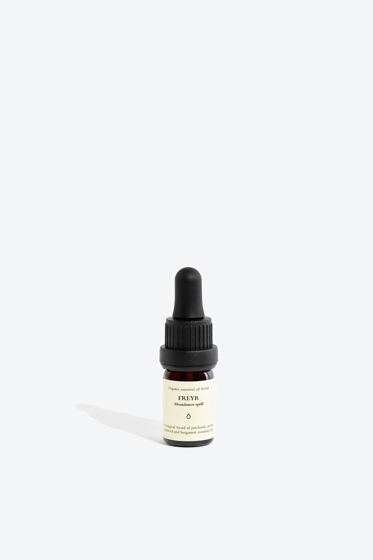Organic essential oil blend Freyr by Smells Like Spells in elegant glass bottle with natural label, representing financial prosperity and Norse mythology, sold by House of Woven Stories.