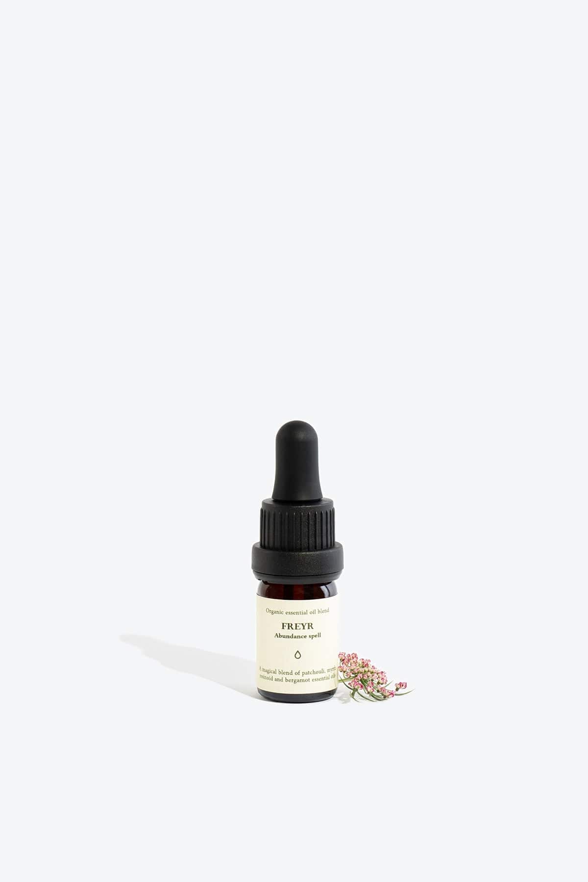 Organic essential oil blend Freyr by Smells Like Spells in elegant glass bottle with natural label, representing financial prosperity and Norse mythology, sold by House of Woven Stories.