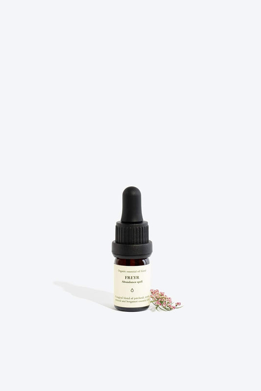 Organic essential oil blend Freyr by Smells Like Spells in elegant glass bottle with natural label, representing financial prosperity and Norse mythology, sold by House of Woven Stories.
