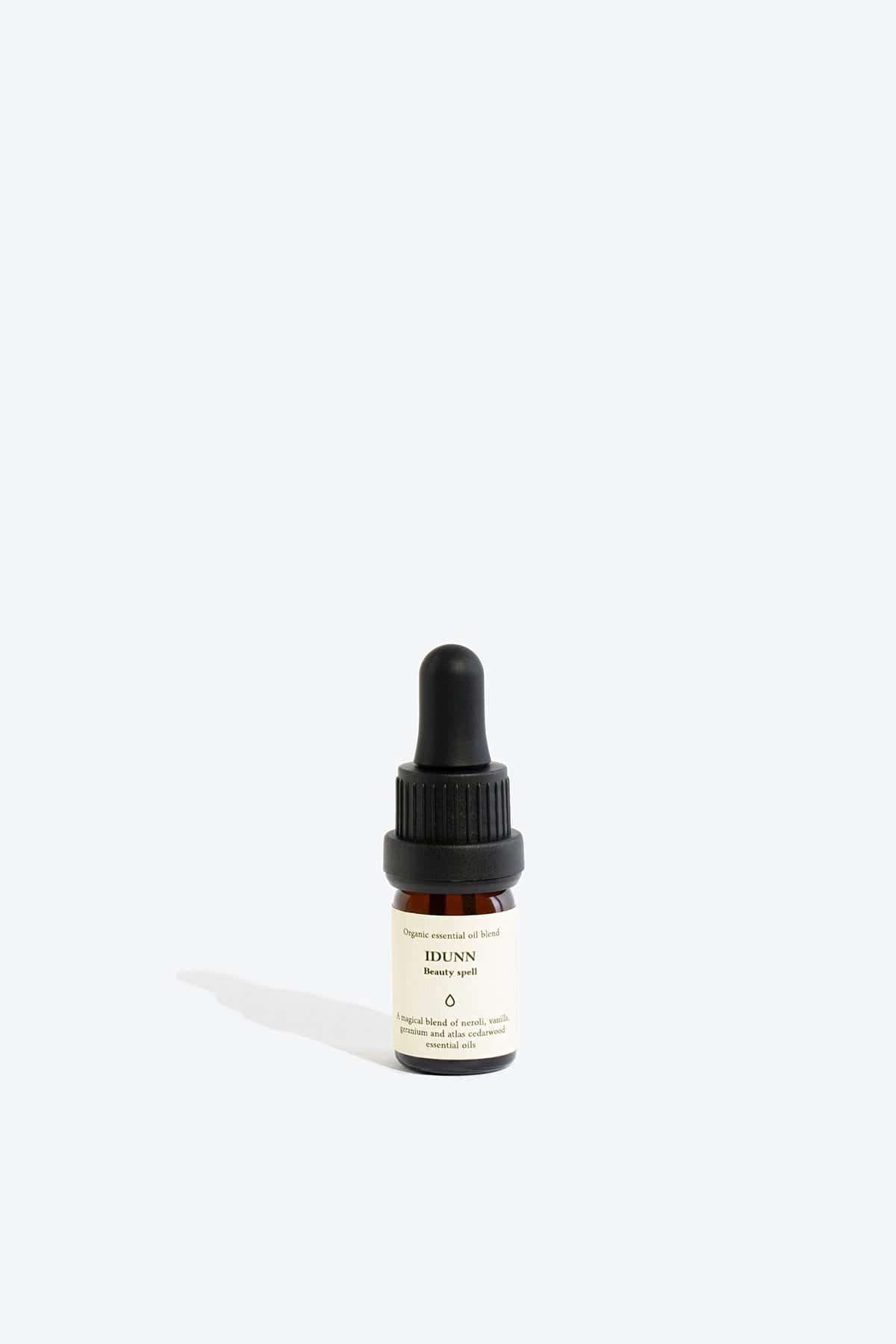Essential organic oil blend Idunn by Smells Like Spells in amber glass bottle with dropper, natural skincare, Norse goddess of youth inspired fragrance, available at House of Woven Stories.
