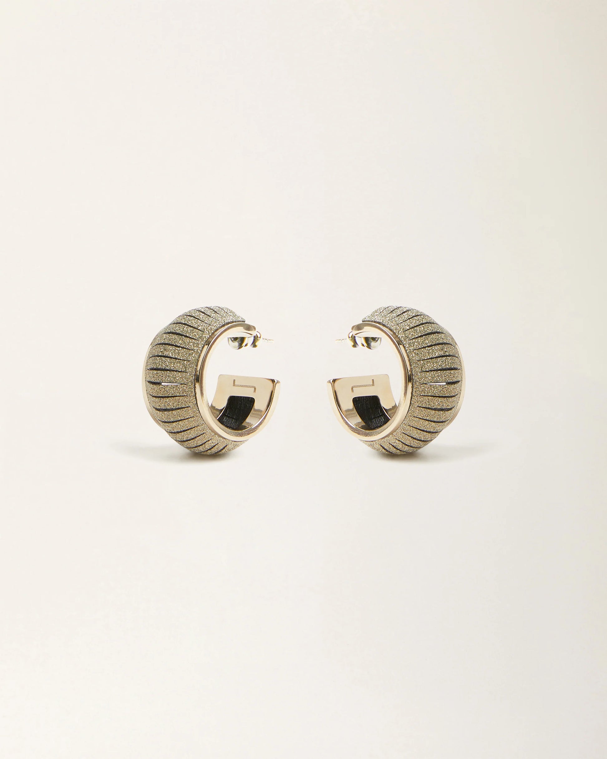 Cosmo Crystal Gold leather earrings by SO-LE STUDIO, handcrafted in Tuscany, softly rounded gold-toned design with crystal accents on the ears