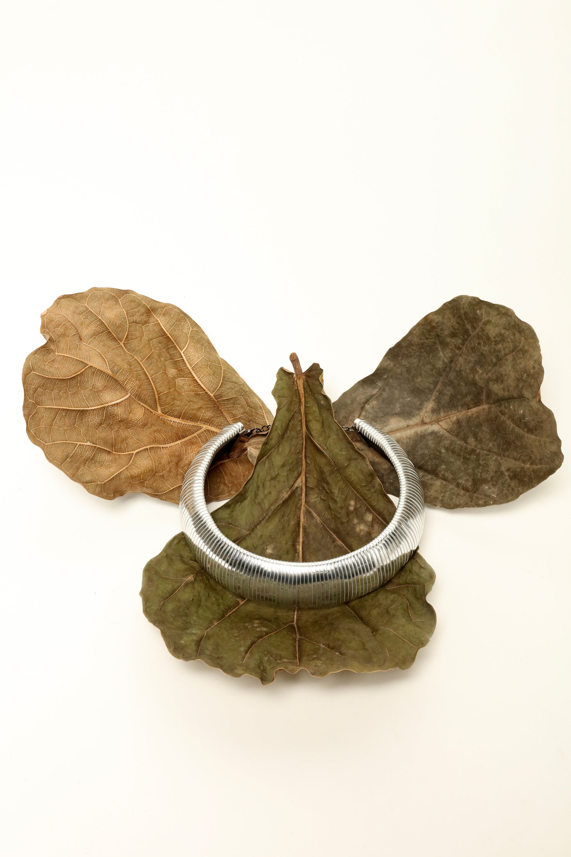 Halo Silver Foil leather necklace by SO-LE STUDIO, handcrafted in Tuscany, bold circular silver-toned design with foil finish, lightweight and sculptural on the neckline