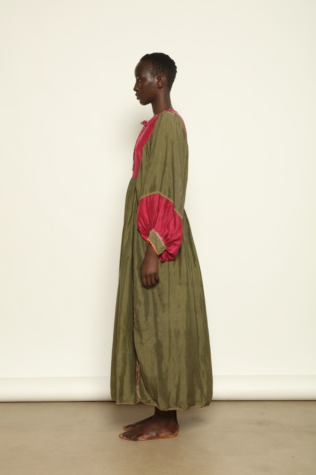 Model Hawa wearing the Serafina Olive Silk Dress by Supernaturae, a handcrafted silk dress with botanical dyes, hand-crochet edges and flowing 1970s-inspired silhouette.