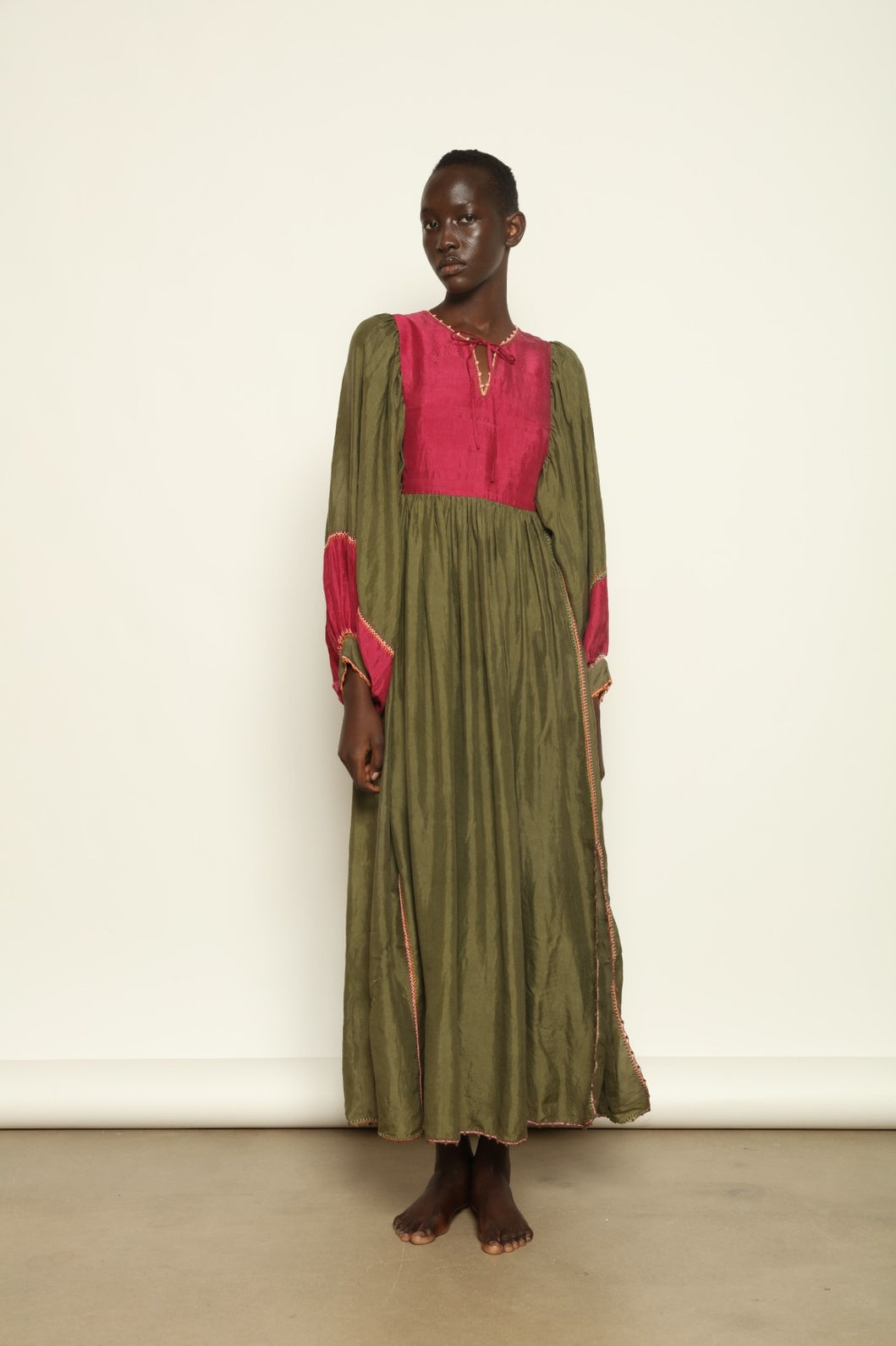 Model Hawa wearing the Serafina Olive Silk Dress by Supernaturae, a handcrafted silk dress with botanical dyes, hand-crochet edges and flowing 1970s-inspired silhouette.
