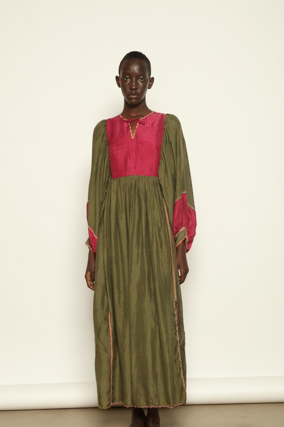 Model Hawa wearing the Serafina Olive Silk Dress by Supernaturae, a handcrafted silk dress with botanical dyes, hand-crochet edges and flowing 1970s-inspired silhouette.