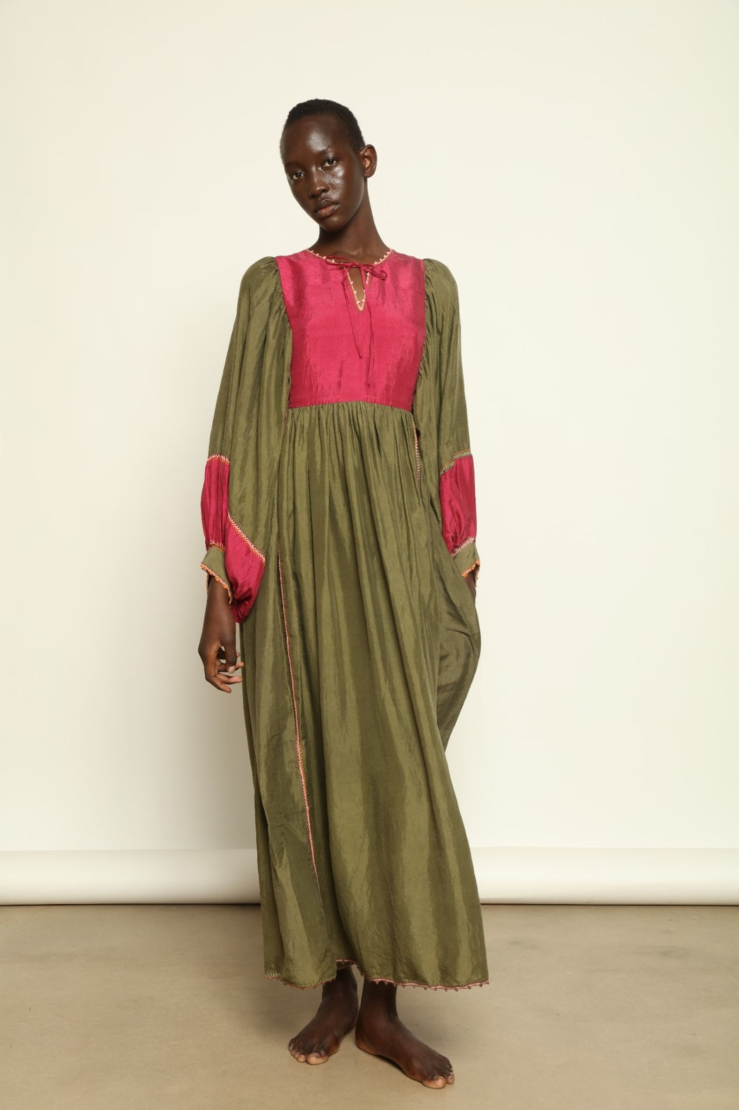 Model Hawa wearing the Serafina Olive Silk Dress by Supernaturae, a handcrafted silk dress with botanical dyes, hand-crochet edges and flowing 1970s-inspired silhouette.