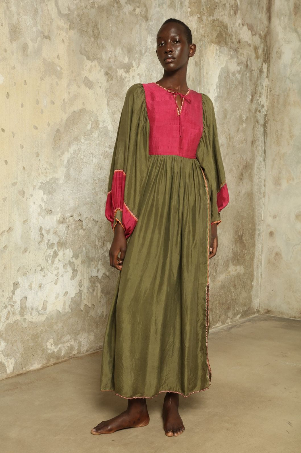 Model Hawa wearing the Serafina Olive Silk Dress by Supernaturae, a handcrafted silk dress with botanical dyes, hand-crochet edges and flowing 1970s-inspired silhouette.