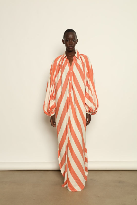 Model is wearing The Touareg Dress with Balloon Sleeve by Marrakshi Life, part of House of Nomad Stories collection, handwoven artisanal cotton dress with sweeping silhouette and dramatic balloon sleeves