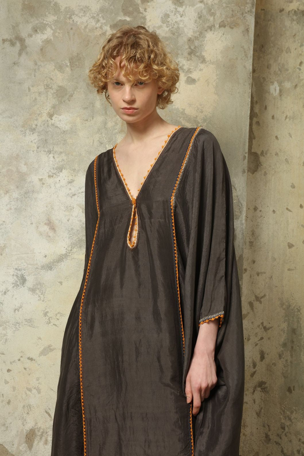 Model is wearing the Thea Grey Silk Dress by Supernaturae x HONS, crafted in handwoven silk from Murshidabad, featuring a relaxed flowing silhouette, elegant open back and natural hand-dyed grey tones. Part of the House of Woven Stories selection