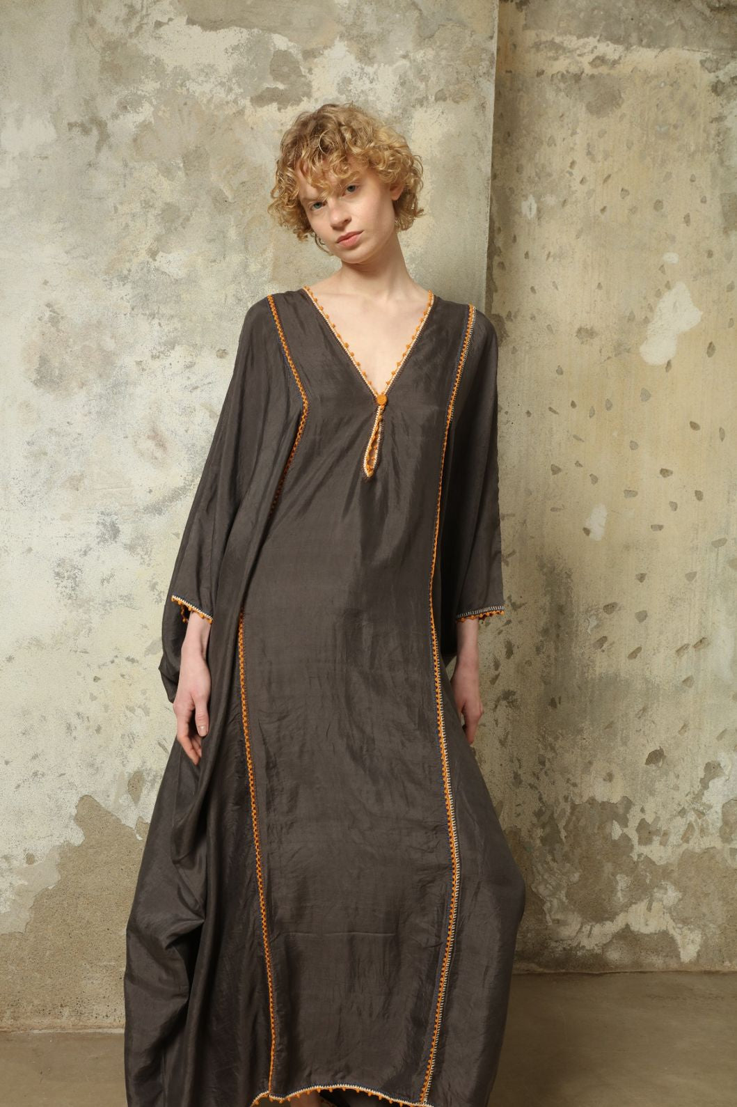 Model is wearing the Thea Grey Silk Dress by Supernaturae x HONS, crafted in handwoven silk from Murshidabad, featuring a relaxed flowing silhouette, elegant open back and natural hand-dyed grey tones. Part of the House of Woven Stories selection