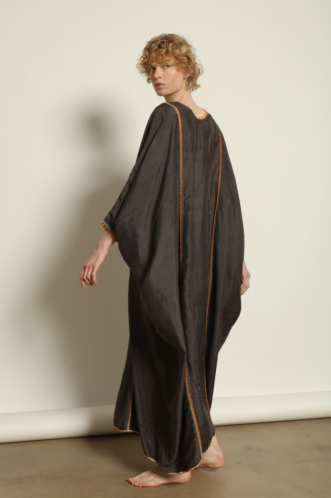 Model is wearing the Thea Grey Silk Dress by Supernaturae x HONS, crafted in handwoven silk from Murshidabad, featuring a relaxed flowing silhouette, elegant open back and natural hand-dyed grey tones. Part of the House of Woven Stories selection