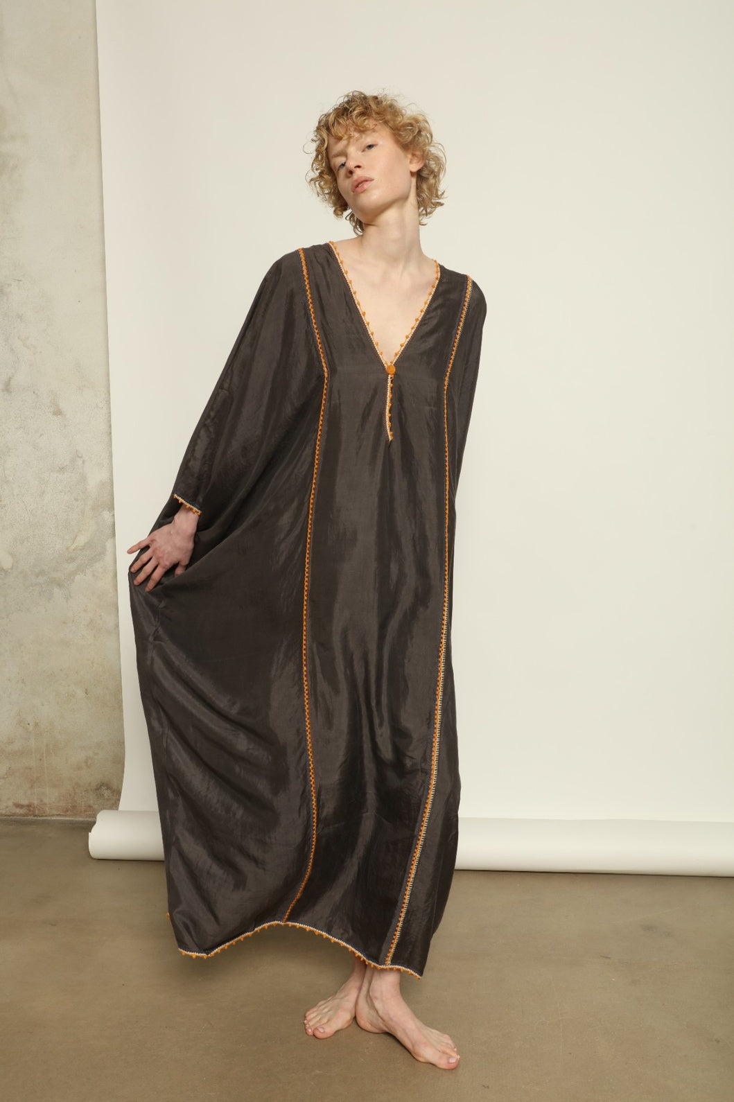 Model is wearing the Thea Grey Silk Dress by Supernaturae x HONS, crafted in handwoven silk from Murshidabad, featuring a relaxed flowing silhouette, elegant open back and natural hand-dyed grey tones. Part of the House of Woven Stories selection